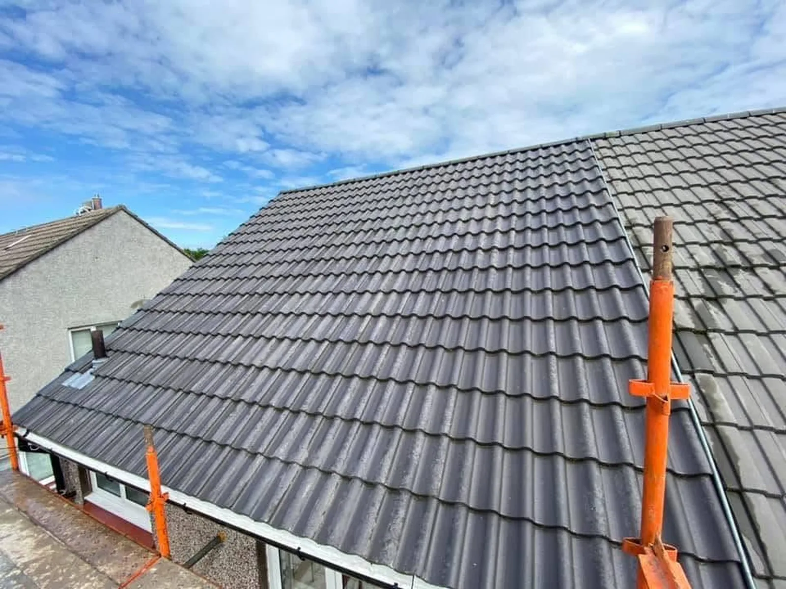 Newly re-tiled grey pitched roof completed by Thomas Ellis Property Care in Flintshire